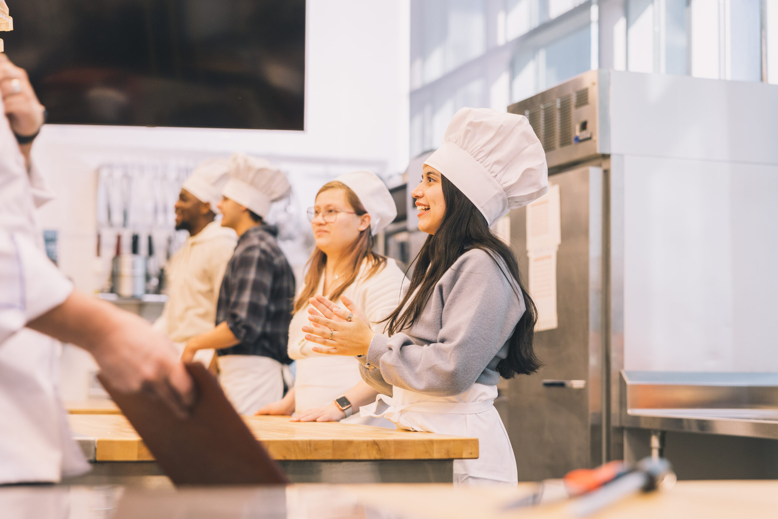 A group of students participate in a culinary class